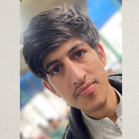 A man in a alice blue shirt with a thinking expression